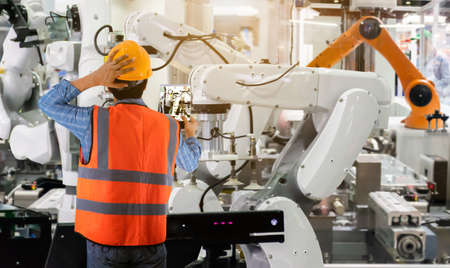 Engineering controlling machinery and industrial robots of things technology man using for controlの写真素材