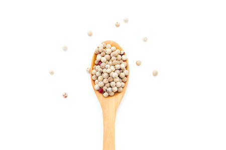 Pepper spices in a wooden spoon on a white backgroundの写真素材