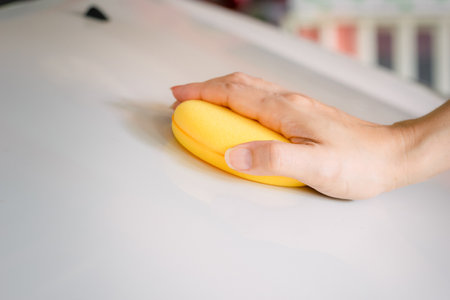 Yellow sponge Polishing and cleaning the carの写真素材