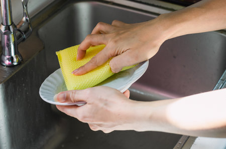 Clean the dishes in the kitchen.