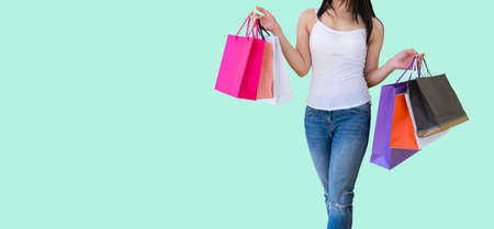 Woman carrying paper bags walking shoppingの写真素材