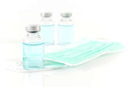 Antiviral vaccine bottle and medical stethoscope on a white backgroundの写真素材