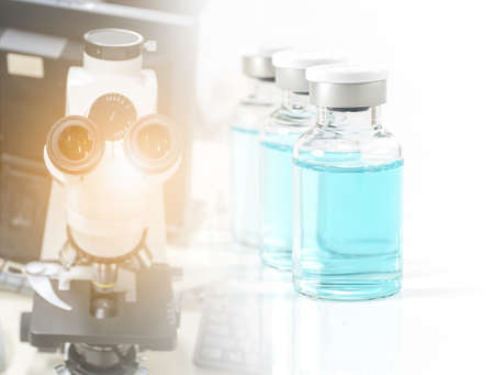 Antiviral vaccine bottle and medical stethoscope on a white backgroundの写真素材