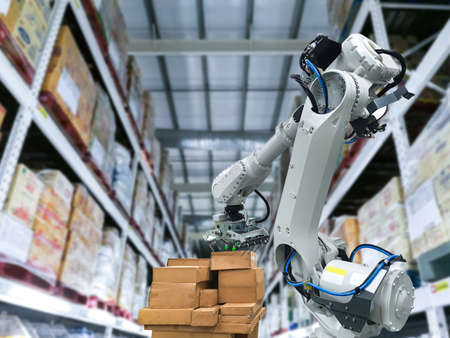 Industrial robotic arm loading carton for holding a packageの写真素材