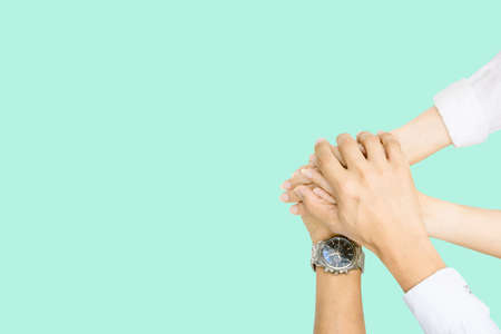 Hands clasped in collaboration top view of individuals bringing their hands together to signify unity and teamworkの写真素材