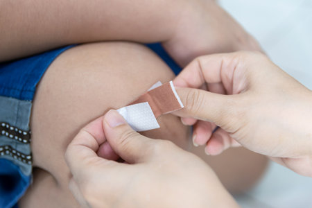 Plaster wound dressing on the child's legの写真素材