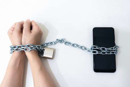Mobile phone chained social media concept to the hands telephoneの写真素材