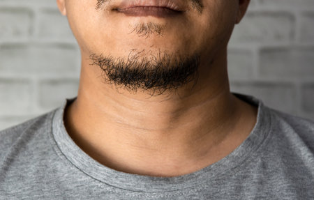 man asia with a long beard on the chin close upの写真素材