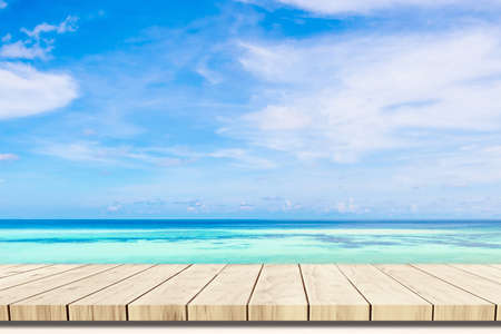 Top of wood balcony table with seascape and palm leaves, sea and sky at beach