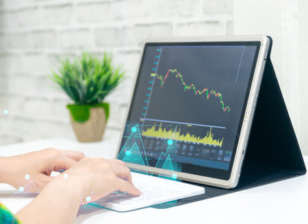 A business examines the financial graph of sales growth on the computerの写真素材