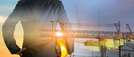 a man in suit holding helmet Industrial and construction design conceptsの写真素材