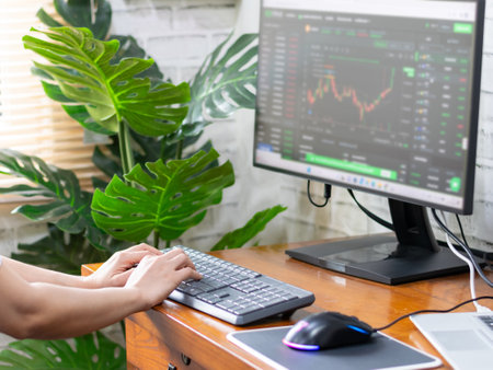 Woman analyzing graphs in progress money on the table doing workの写真素材