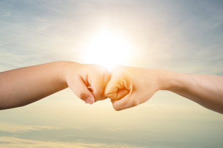 Fist bump concept, success, commitment to work

 Children's and adults' handsの写真素材