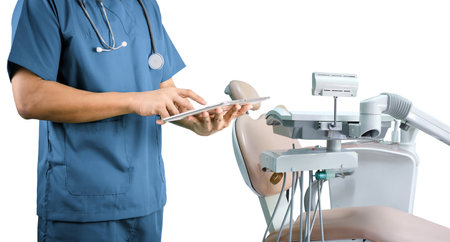 Dentist holding tablet and dental tableの写真素材