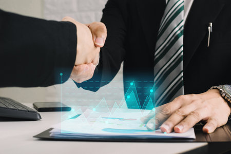 Businessmen shake hands and have successful investments.の写真素材