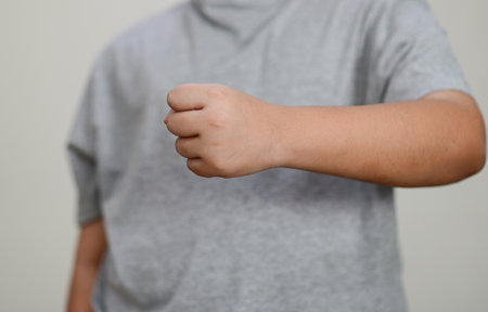 The child's hand is clenched into a fist.の写真素材