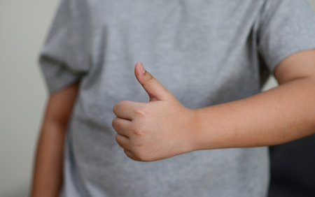 Child's hand thumb up is a symbolの写真素材