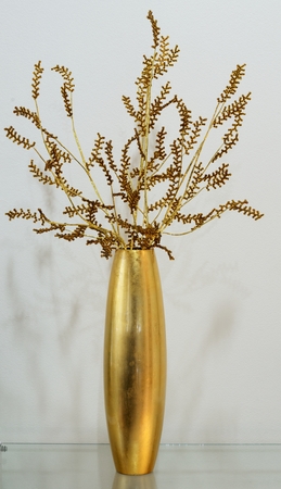 Gold vase with gold flowerの写真素材