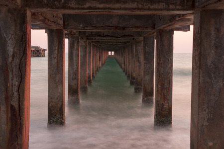 Waves sea and beach under the bridge in the Mae Rumphueng Beach in  Rayong, Thailandの写真素材