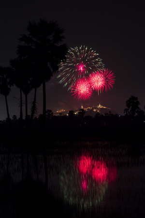 Beautiful colorful firework festival at night sky in Phra Nakhon Khiri (Khao Wang) with sugar palm Phetchaburi province,Thailandの写真素材