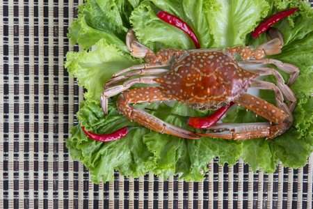 Steamed blue swimming crab and spicy sauce on a white Plate the wooden dish made of Japanese style bamboo, Thai style food.の写真素材