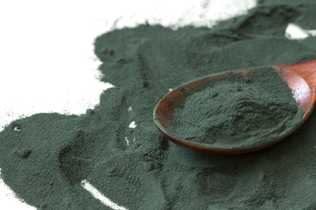 spoon of spirulina algae powder isolated on white background. Top viewの写真素材
