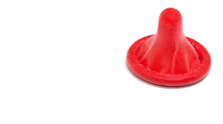 Red condom isolated on white background, Rubber condom use to protection against sexually...