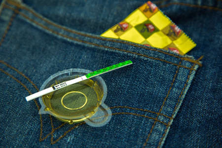 A condom on young Lady fingerの写真素材
