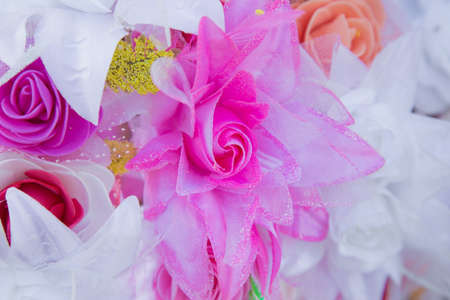 Floral background. Lot of artificial flowers in colorful composition,closeup flowers backgroundの写真素材