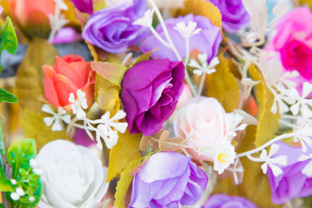 Floral background. Lot of artificial flowers in colorful composition,closeup flowers backgroundの写真素材