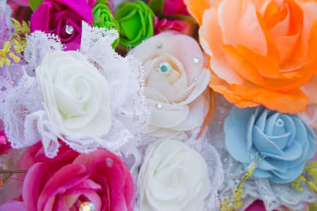 Floral background. Lot of artificial flowers in colorful composition,closeup flowers backgroundの写真素材