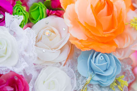 Floral background. Lot of artificial flowers in colorful composition,closeup flowers backgroundの写真素材