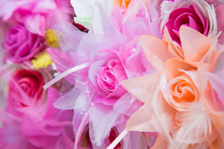 Floral background. Lot of artificial flowers in colorful composition,closeup flowers backgroundの写真素材