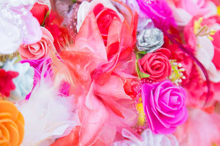 Floral background. Lot of artificial flowers in colorful composition,closeup flowers backgroundの写真素材