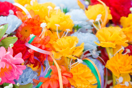 Floral background. Lot of artificial flowers in colorful composition,closeup flowers backgroundの写真素材