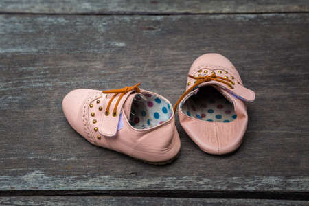 Child's sandals on a wooden backgroundの写真素材