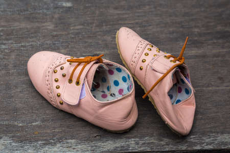 Child's sandals on a wooden backgroundの写真素材
