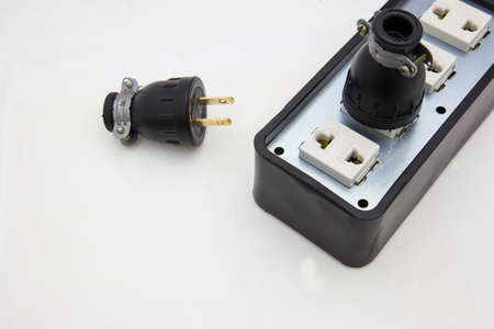 Single black European power plug not grounded with two pins close up on white backgroundの写真素材