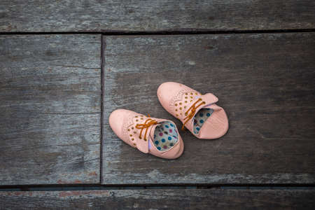 Child's sandals on a wooden backgroundの写真素材