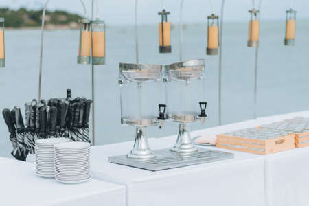 Wedding on the beach .Beach wedding venue setting on the white sand with beautiful panoramic ocean view background, Pink and red rose petals on the aisleの写真素材