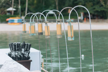 Wedding on the beach .Beach wedding venue setting on the white sand with beautiful panoramic ocean view background, Pink and red rose petals on the aisleの写真素材