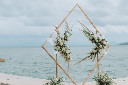 Wedding on the beach .Beach wedding venue setting on the white sand with beautiful panoramic ocean view background, Pink and red rose petals on the aisleの写真素材