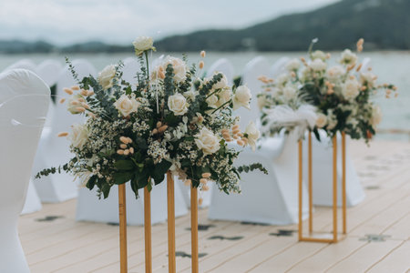 Wedding on the beach .Beach wedding venue setting on the white sand with beautiful panoramic ocean view background, Pink and red rose petals on the aisleの写真素材