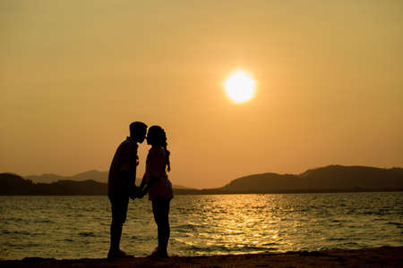 Silhouette young couple at sunset.Valentine's concept.の写真素材