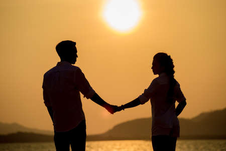 Silhouette young couple at sunset.Valentine's concept.の写真素材