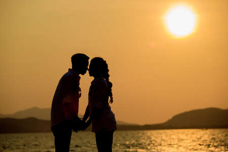 Silhouette young couple at sunset.Valentine's concept.の写真素材
