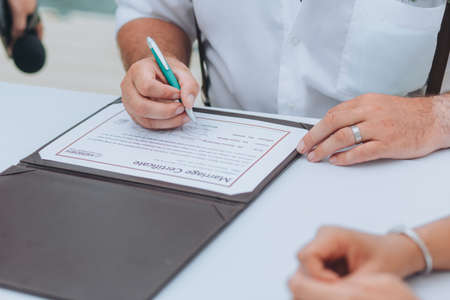 Loving couple filling marriage application form