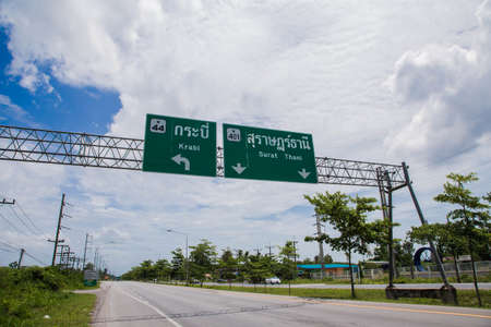 Road sign curved reminds the motorists and vehicles while driving with yellow sign reflecting light to be visible at night at the roadway in countryside of Thailandの写真素材