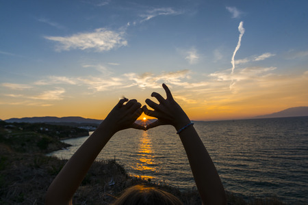 hands at the sunsetの写真素材