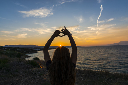 Silhouette girl at the sunsetの写真素材